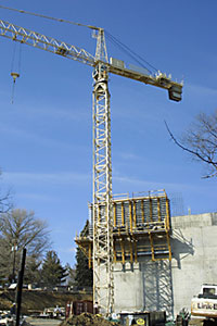 Photo of crane by tower