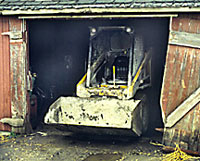Photo of skid-steer loader in barn doorway